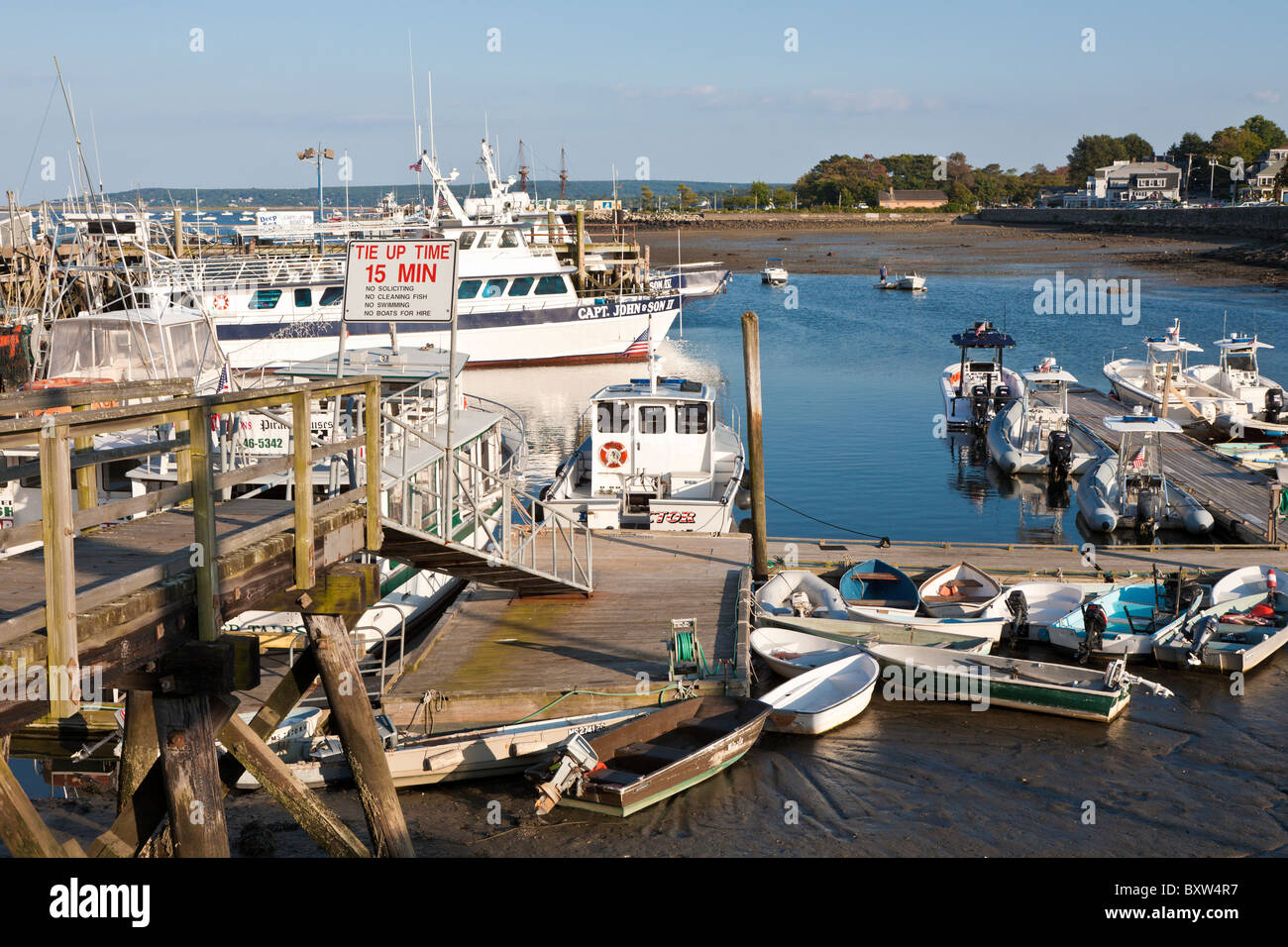 Small boats tied to floating dock in Plymouth Harbor in Plymouth