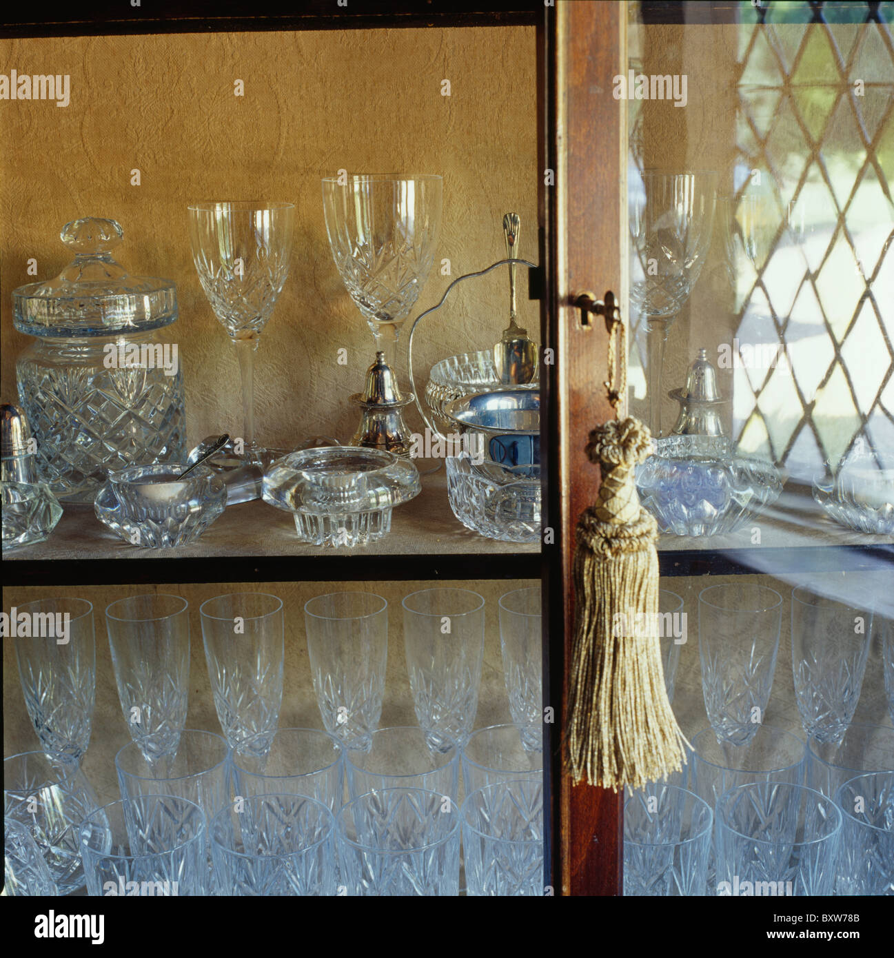 Close Up Of Tassel On Glass Door Antique Cupboard With Display Close Up Of Tassel On Glass Door Antique Cupboard With Display Wine Glasses And Salt Pots
