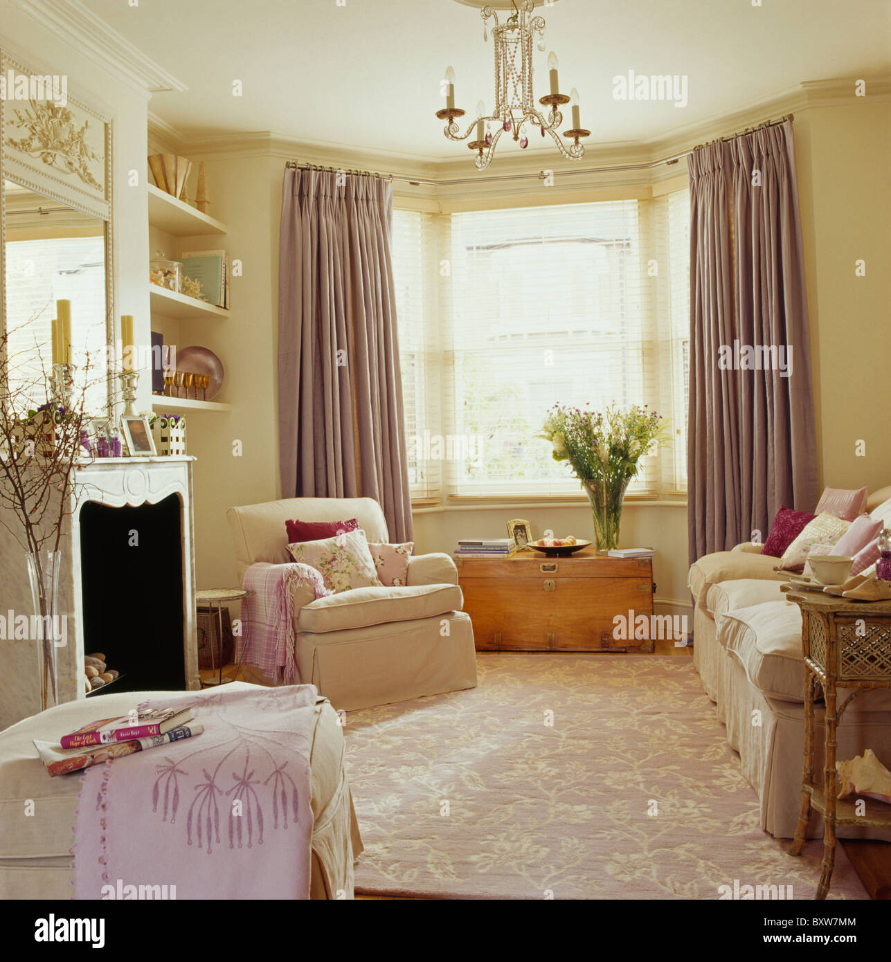 Cream textured carpet in cream living room with pale mauve silk curtains  and cream sofa and armchair Stock Photo - Alamy