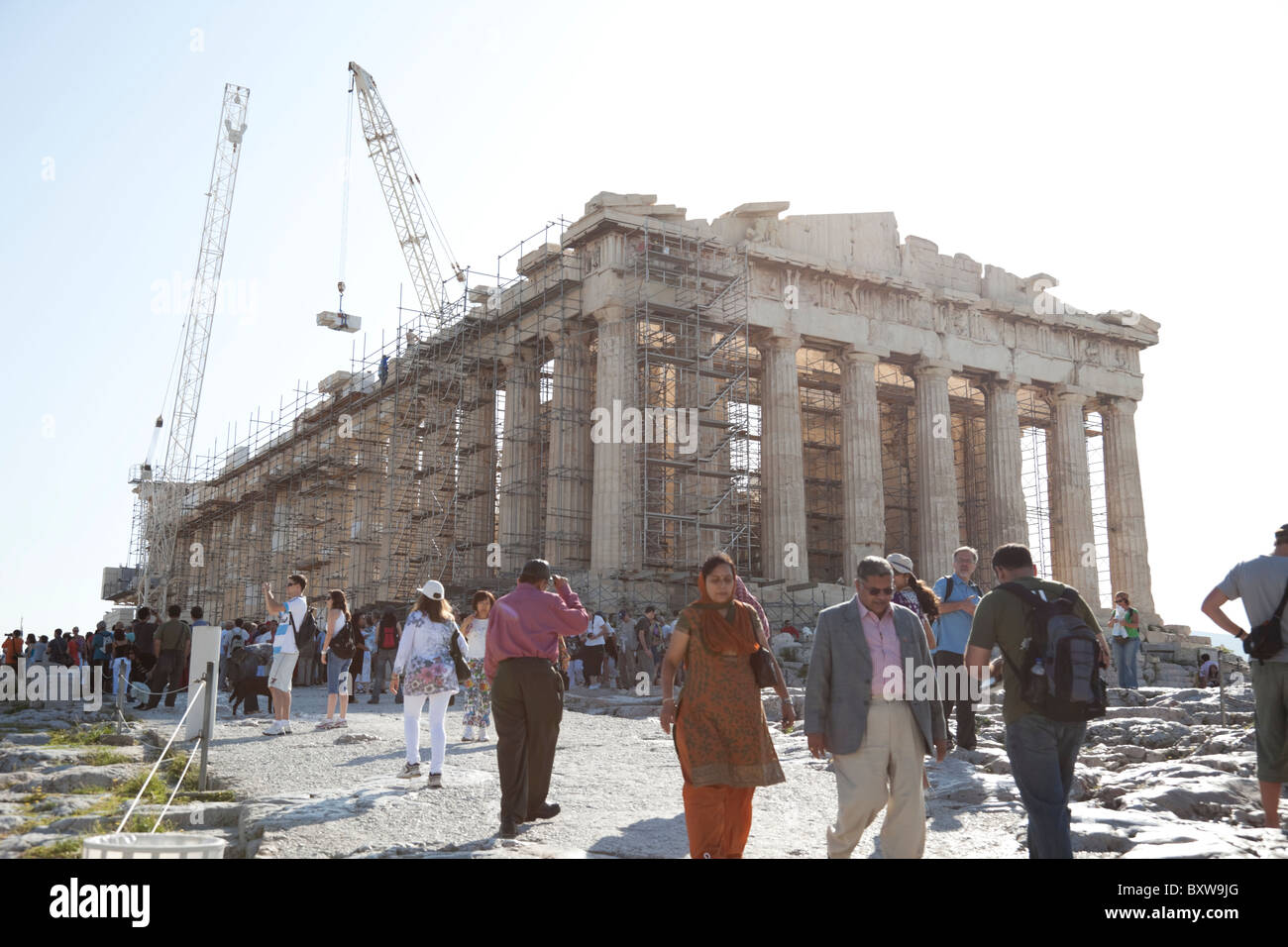 Working scaffolding on Parthenon at Acropolis, with massive tourists surrounding it. Stock Photo