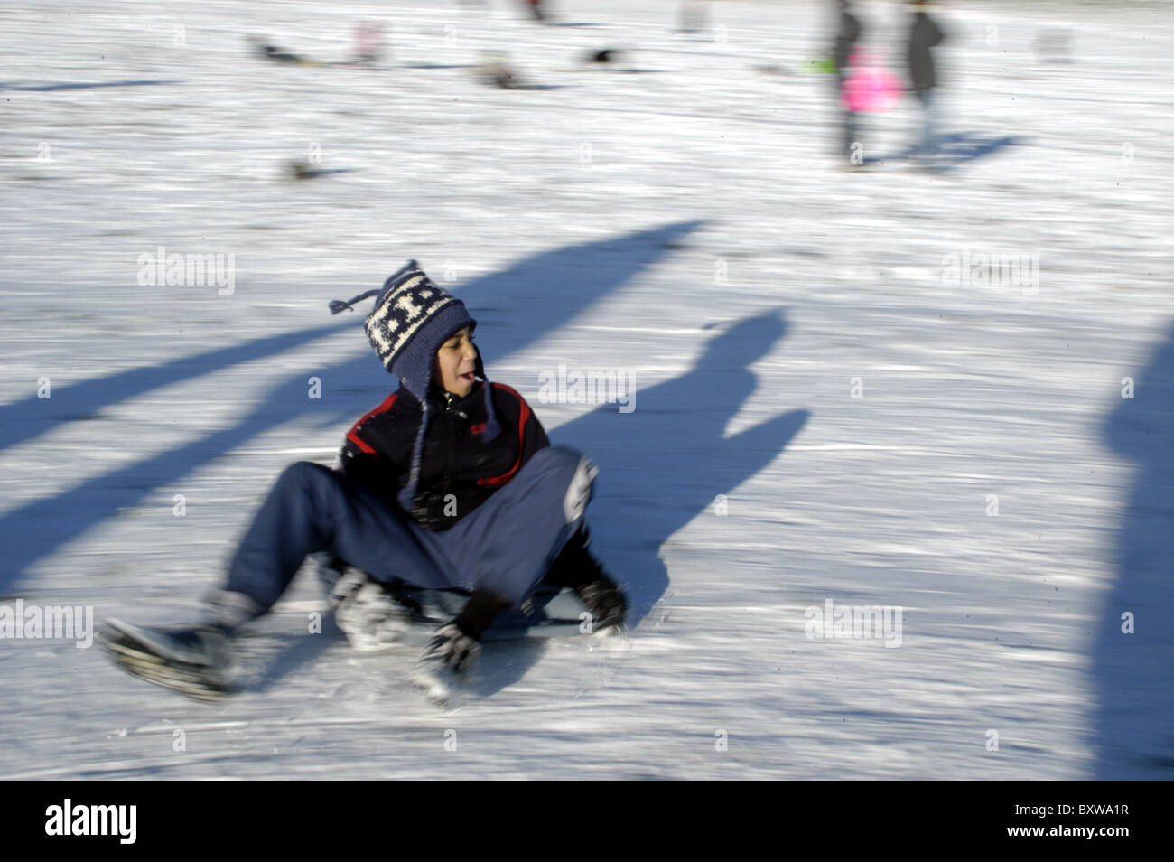 UK. BOY SLIDING ON ICE. HAMPSTEAD HEATH, LONDON Stock Photo Alamy