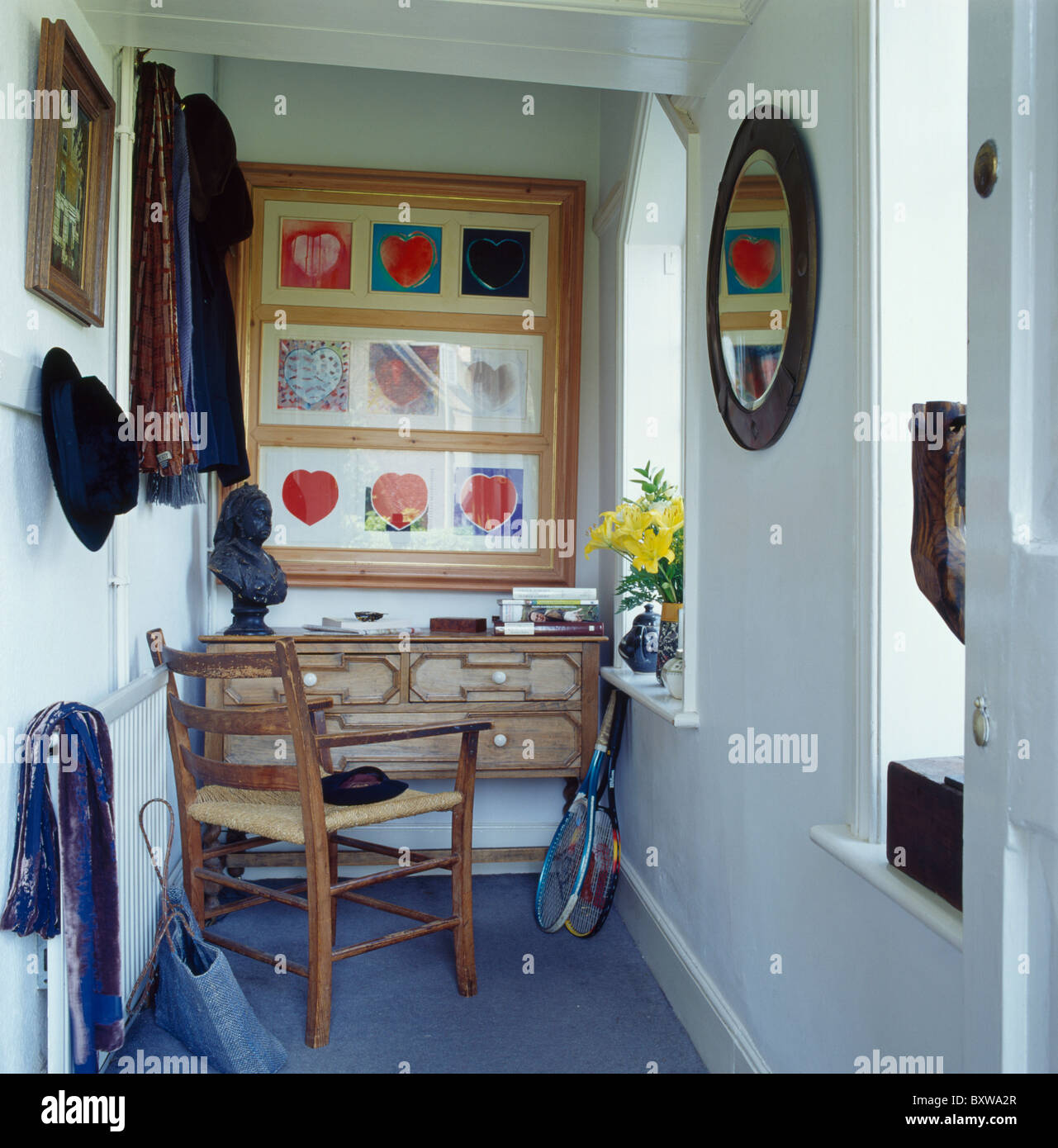 Large collage picture above small desk in study area of narrow white