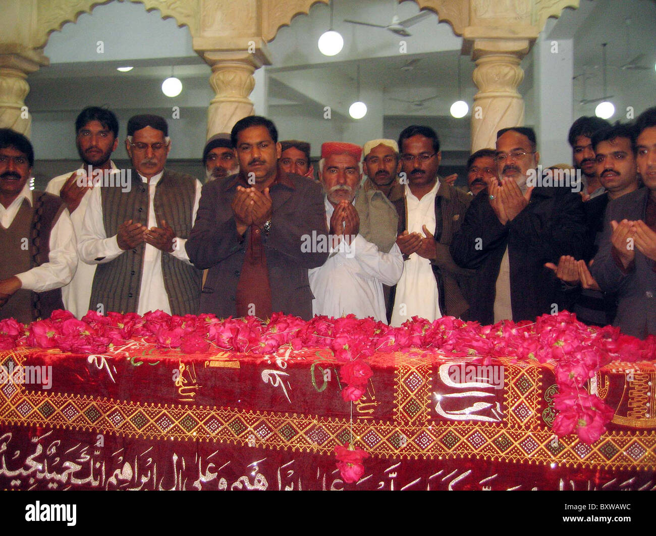 Supporters of Peoples Party offer Dua (pray) at the grave of PPP Founder, Zulfiqar Ali Bhutto at Bhutto Mausoleum on the Stock Photo