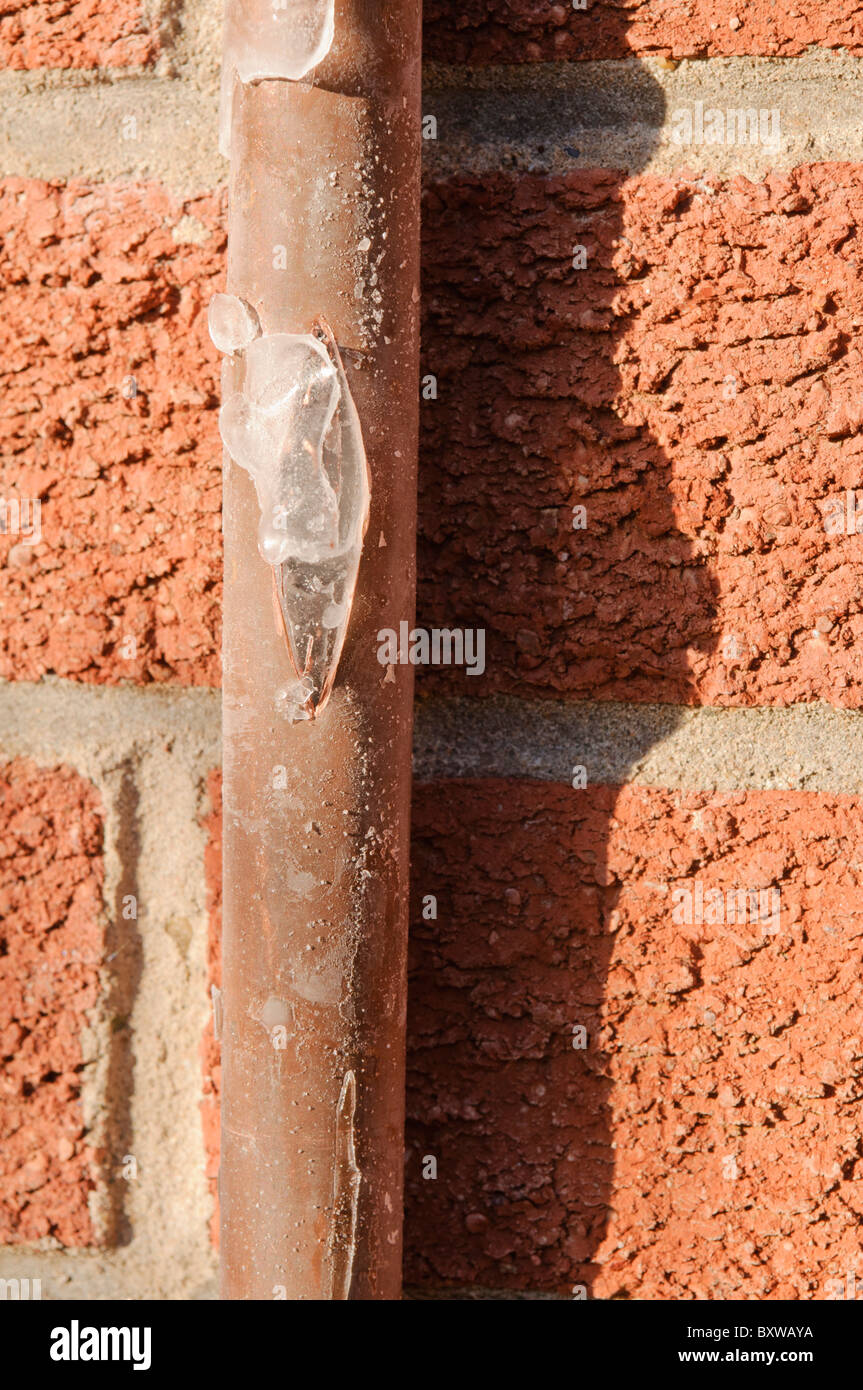 Copper mains water pipe burst open by frozen ice Stock Photo