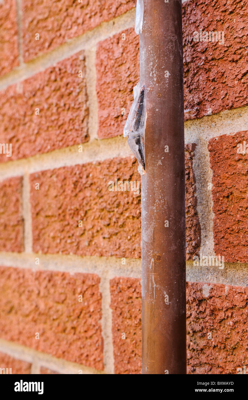 Copper mains water pipe burst open by frozen ice Stock Photo