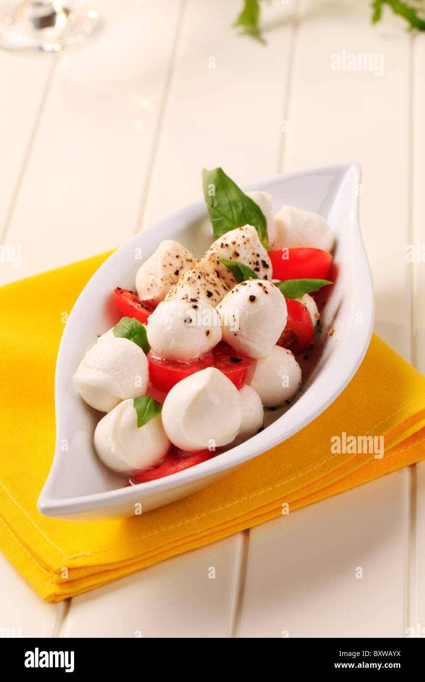 Bowl of mozzarella cheese balls, tomato and basil Stock Photo Alamy