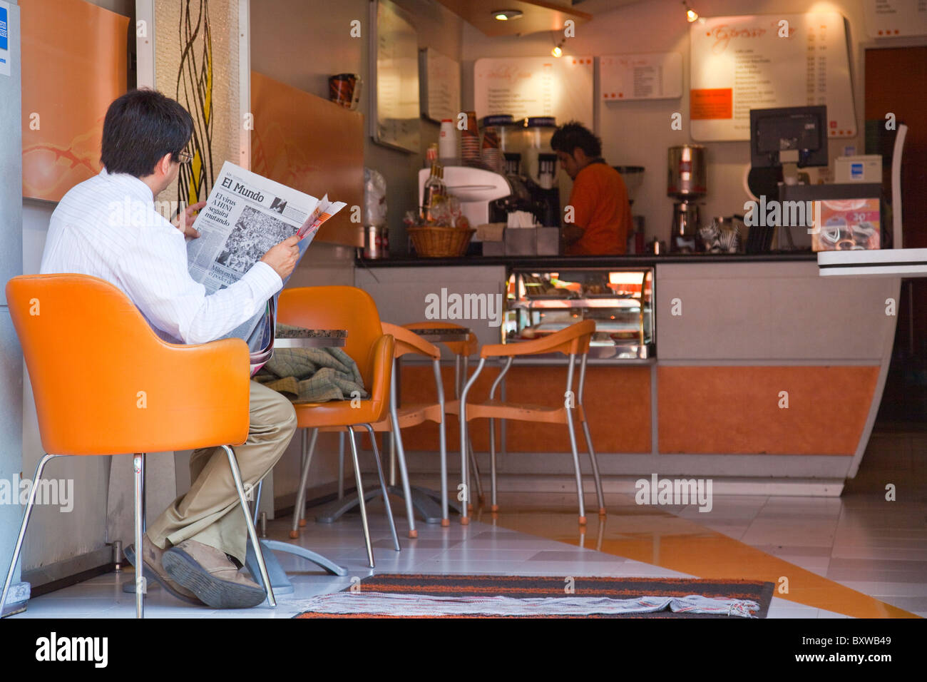Man reading a newspaper in a cafe in the Zona Rosa in Mexico City