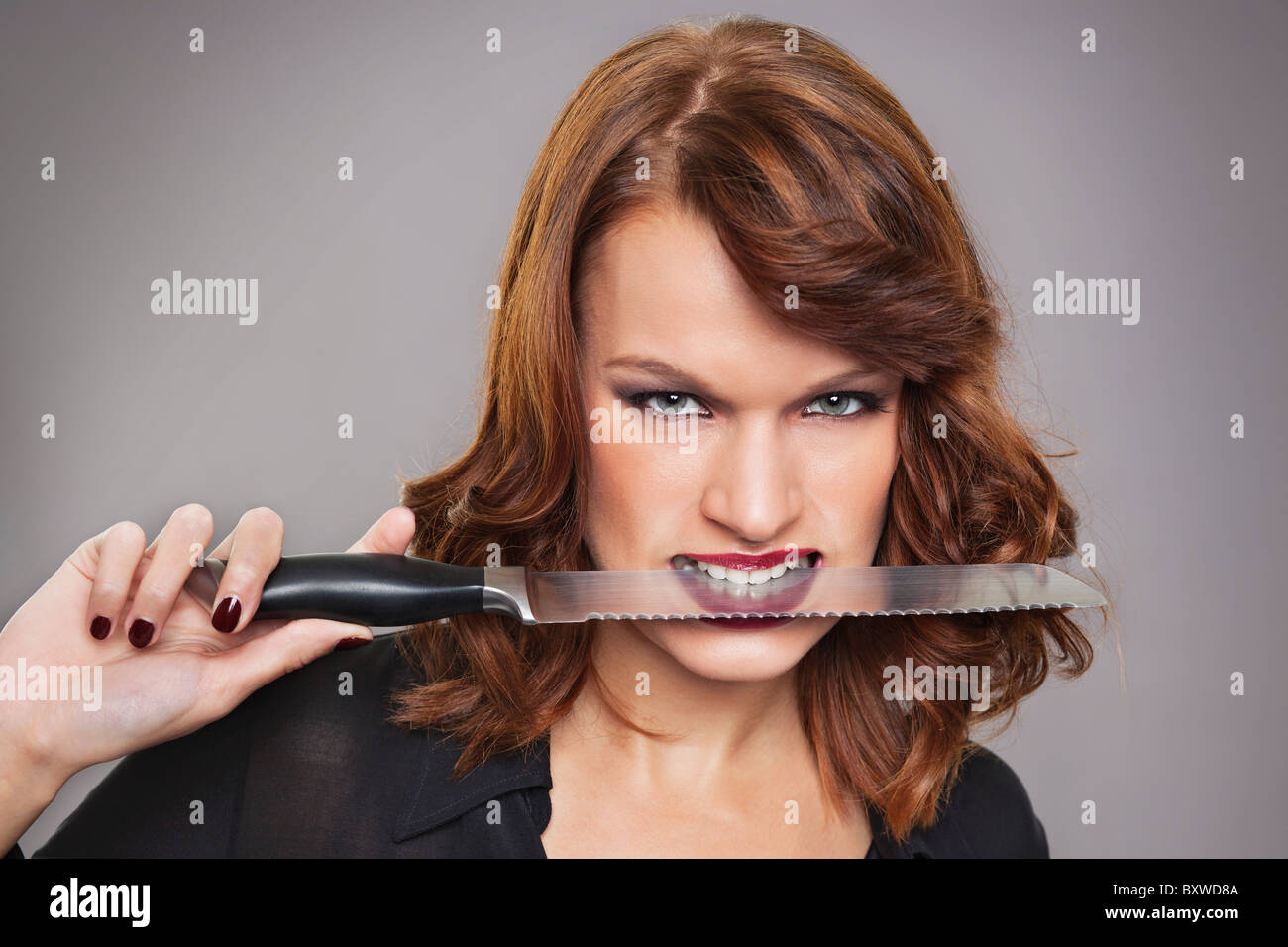 Knife between teeth hi-res stock photography and images - Alamy