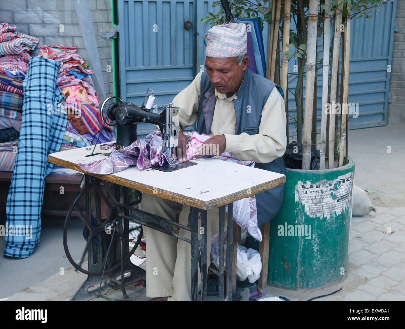 tailor at work with his sewing machine in Kathmandu, Nepal Stock Photo