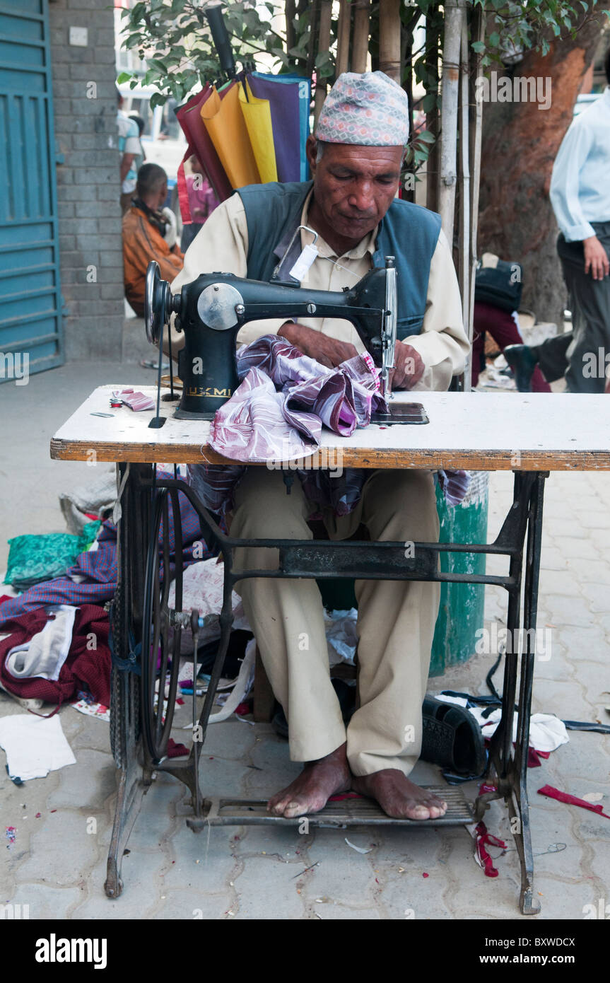 tailor at work with his sewing machine in Kathmandu, Nepal Stock Photo