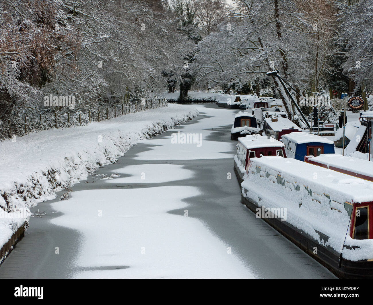 Canal boats in the snow at Boathouse on the River Wey in Godalming Surrey Stock Photo