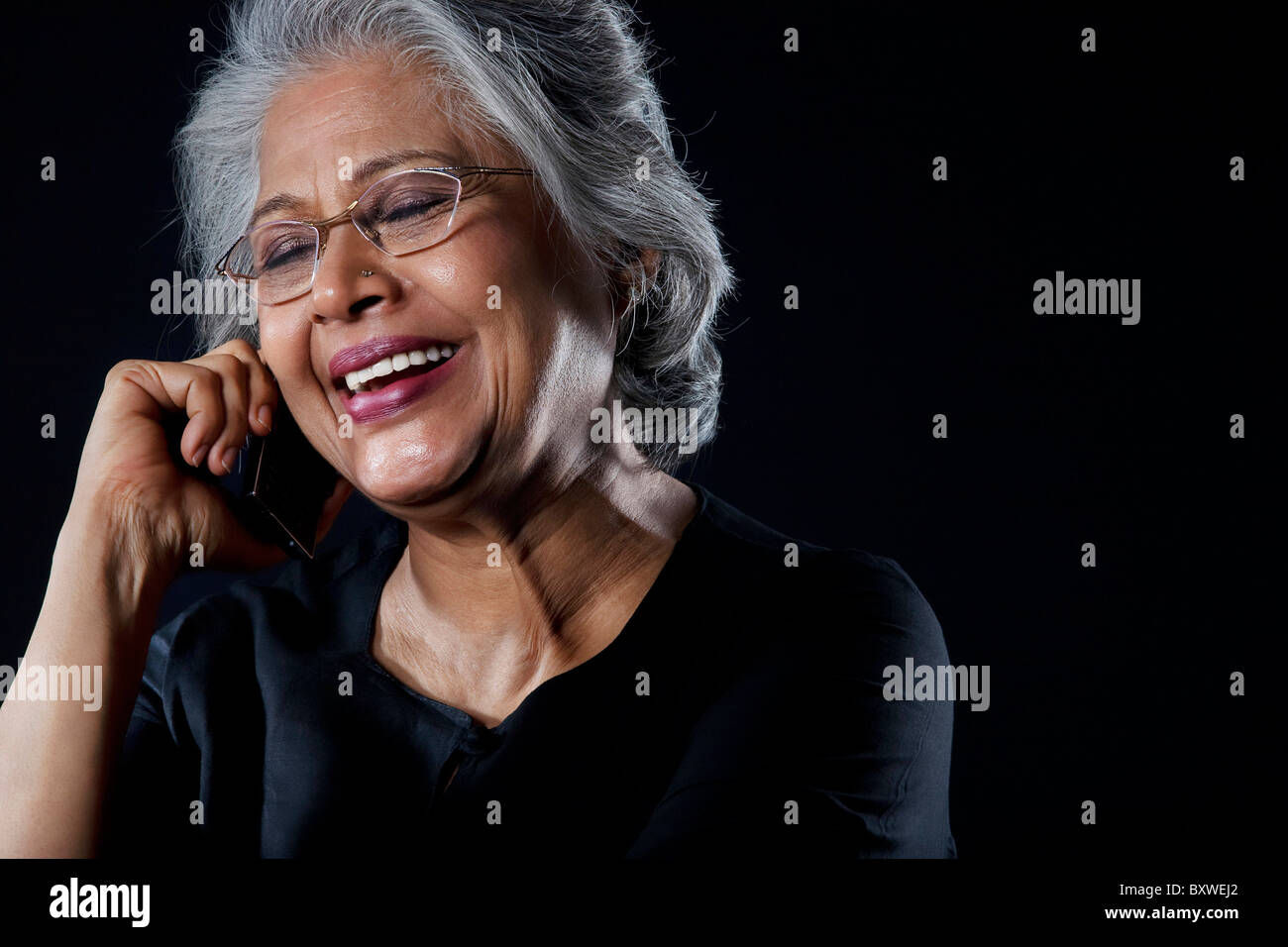 Old woman talking on a mobile phone Stock Photo - Alamy