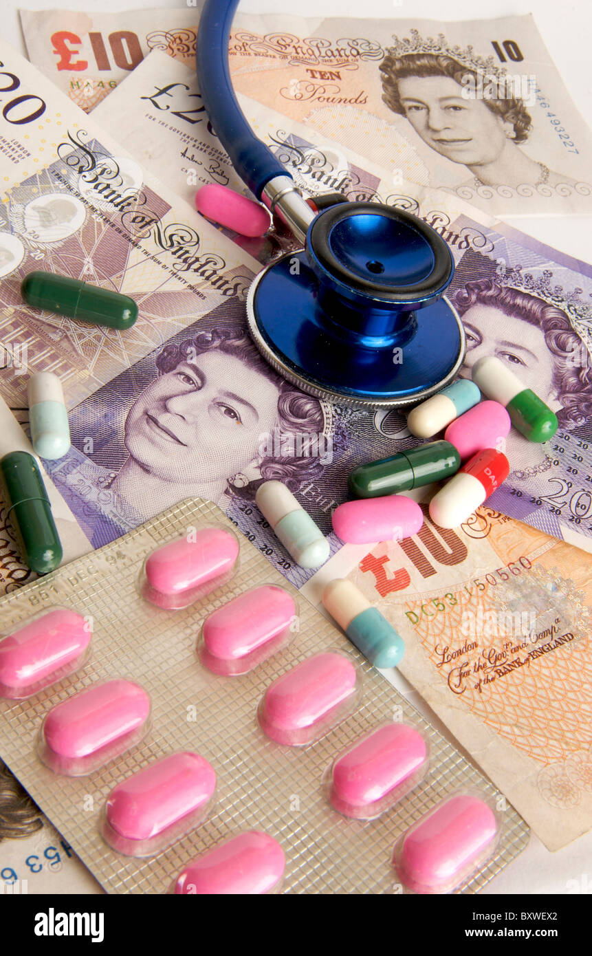 Pound sterling banknotes, stethoscope, pills - NHS health care costs / charges in the UK concept Stock Photo