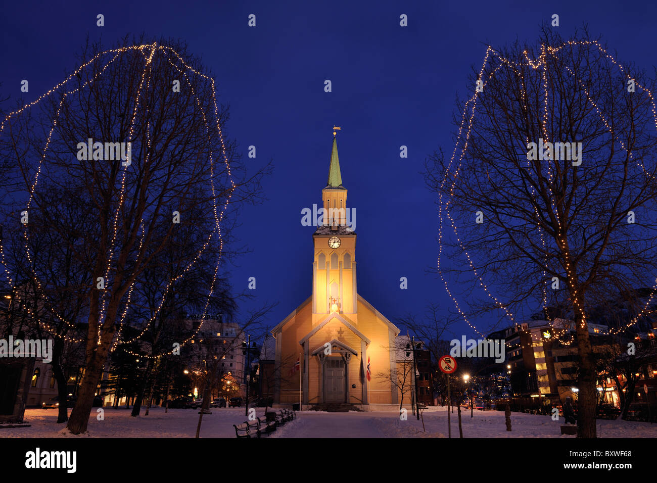 Church in the city center in Tromso, North Norway. Trees decorated for Christmas. Stock Photo