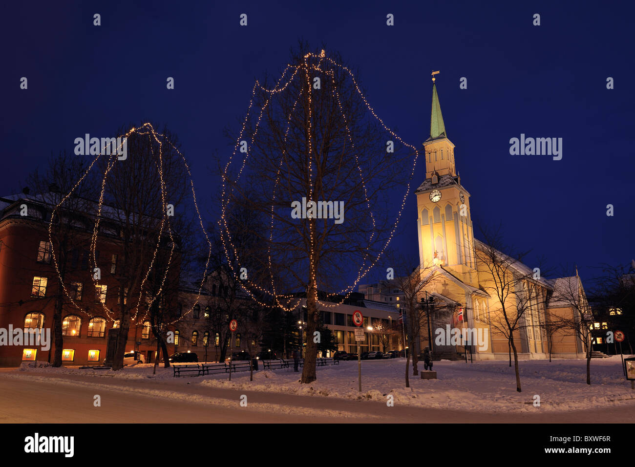 Church in the city center in Tromso, North Norway. Trees decorated for Christmas. Stock Photo