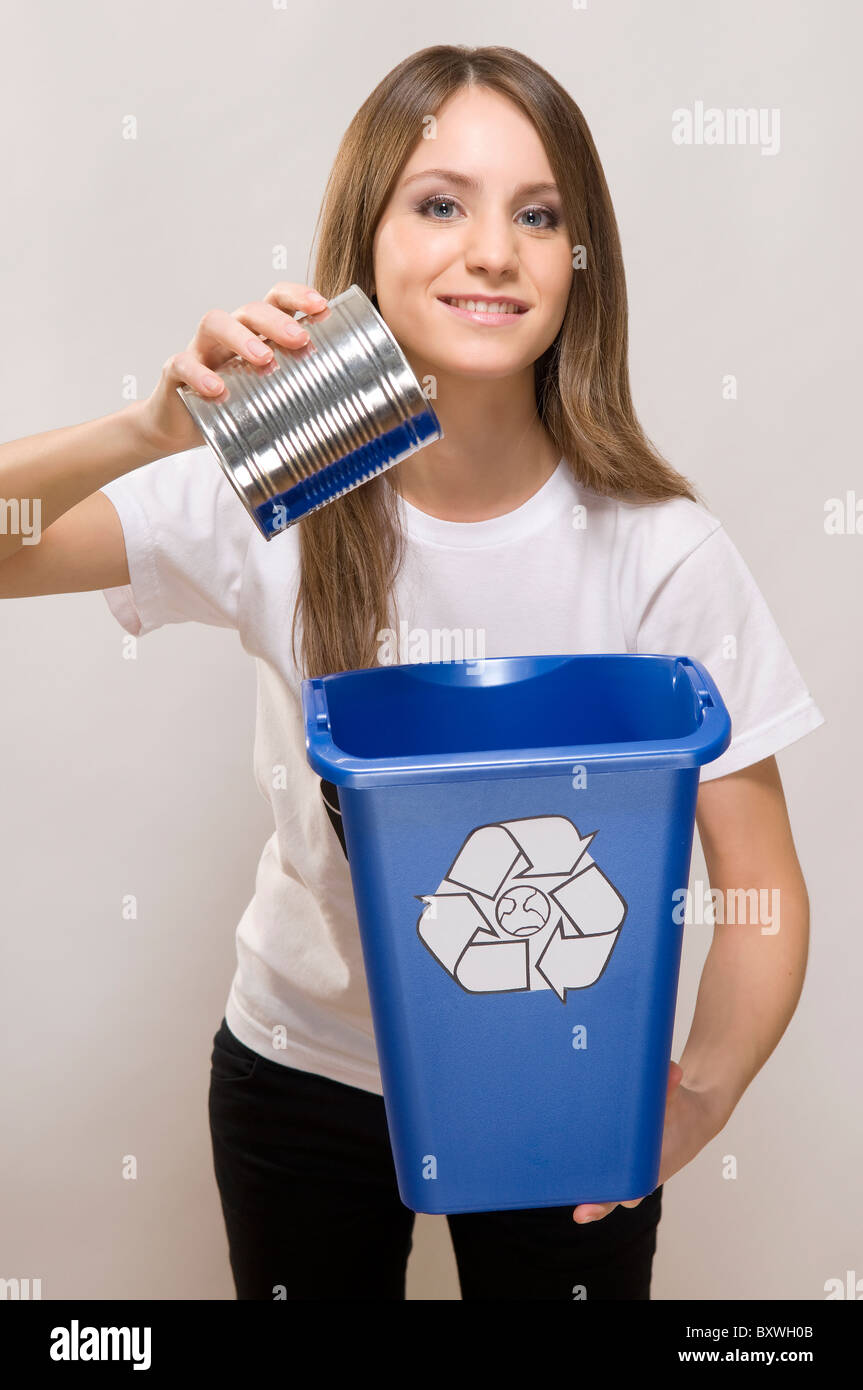 woman putting a tin in recycling bin Stock Photo Alamy