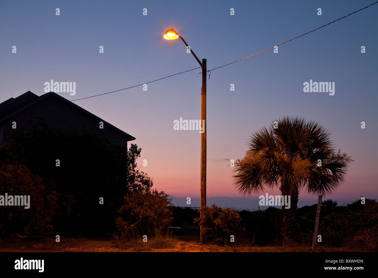 USA, Tybee Island, Street lights along beach front street at dusk on summer evening