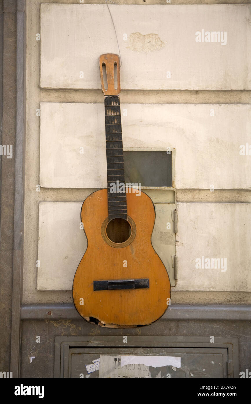 Guitar on wall, Granada, Spain. Stock Photo