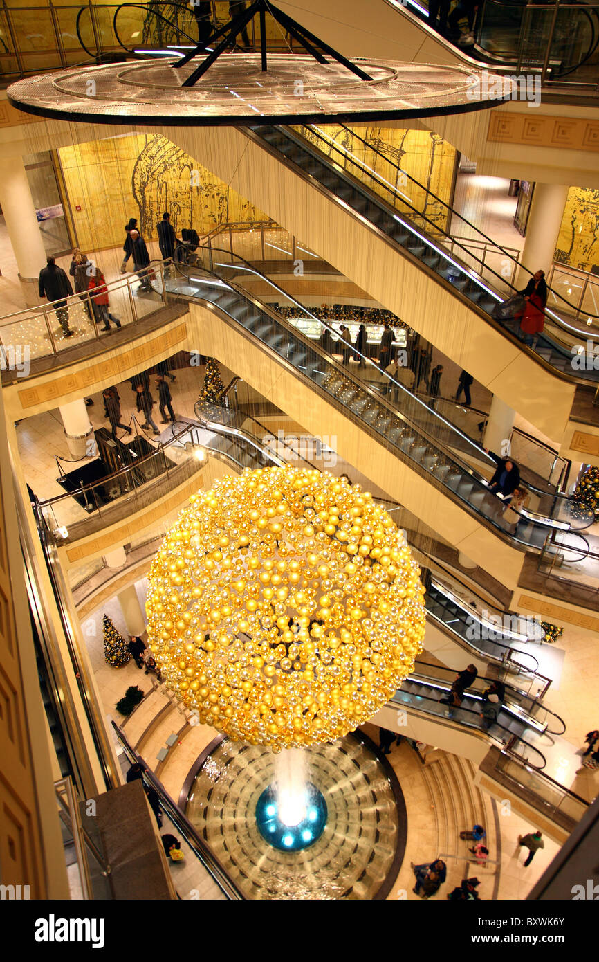 Christmas decoration in a shopping mall.  Many golden Christmas tree balls forms a giant ball. Stock Photo
