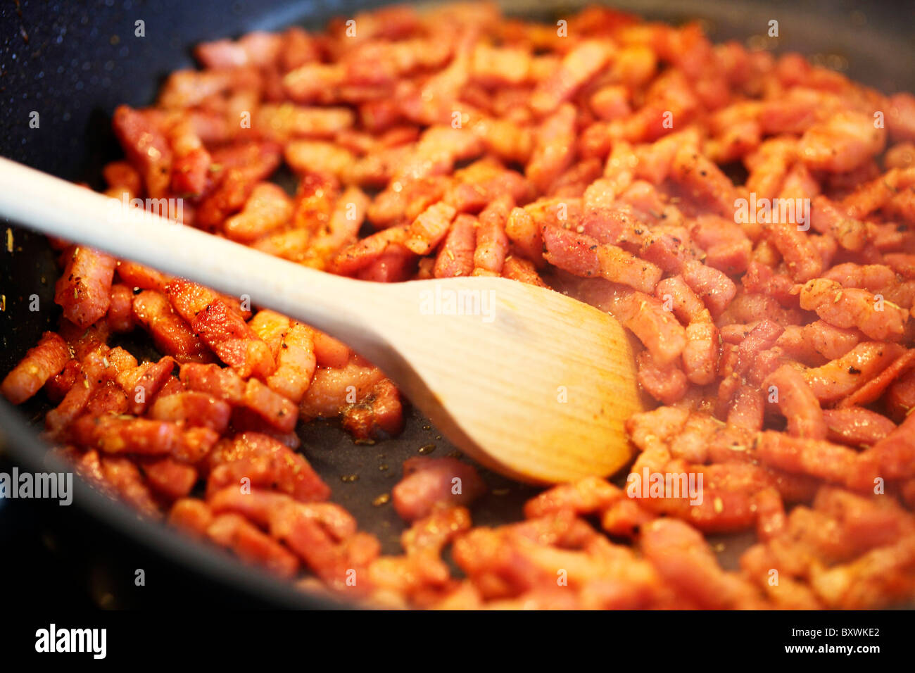 Bacon strips frying in a pan. Stock Photo