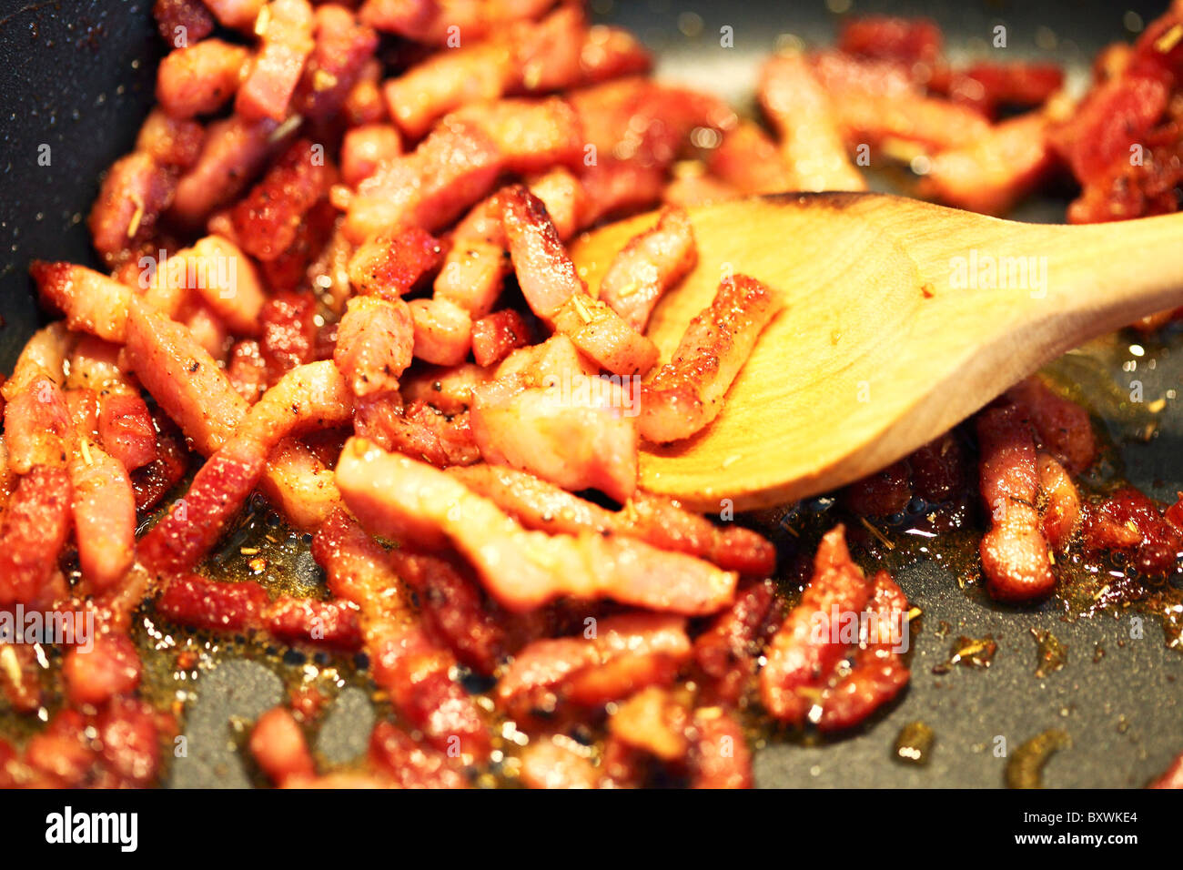 Bacon strips frying in a pan. Stock Photo