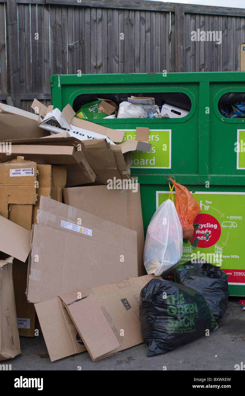 overloaded recycling facilities where people dump refuse beside skips