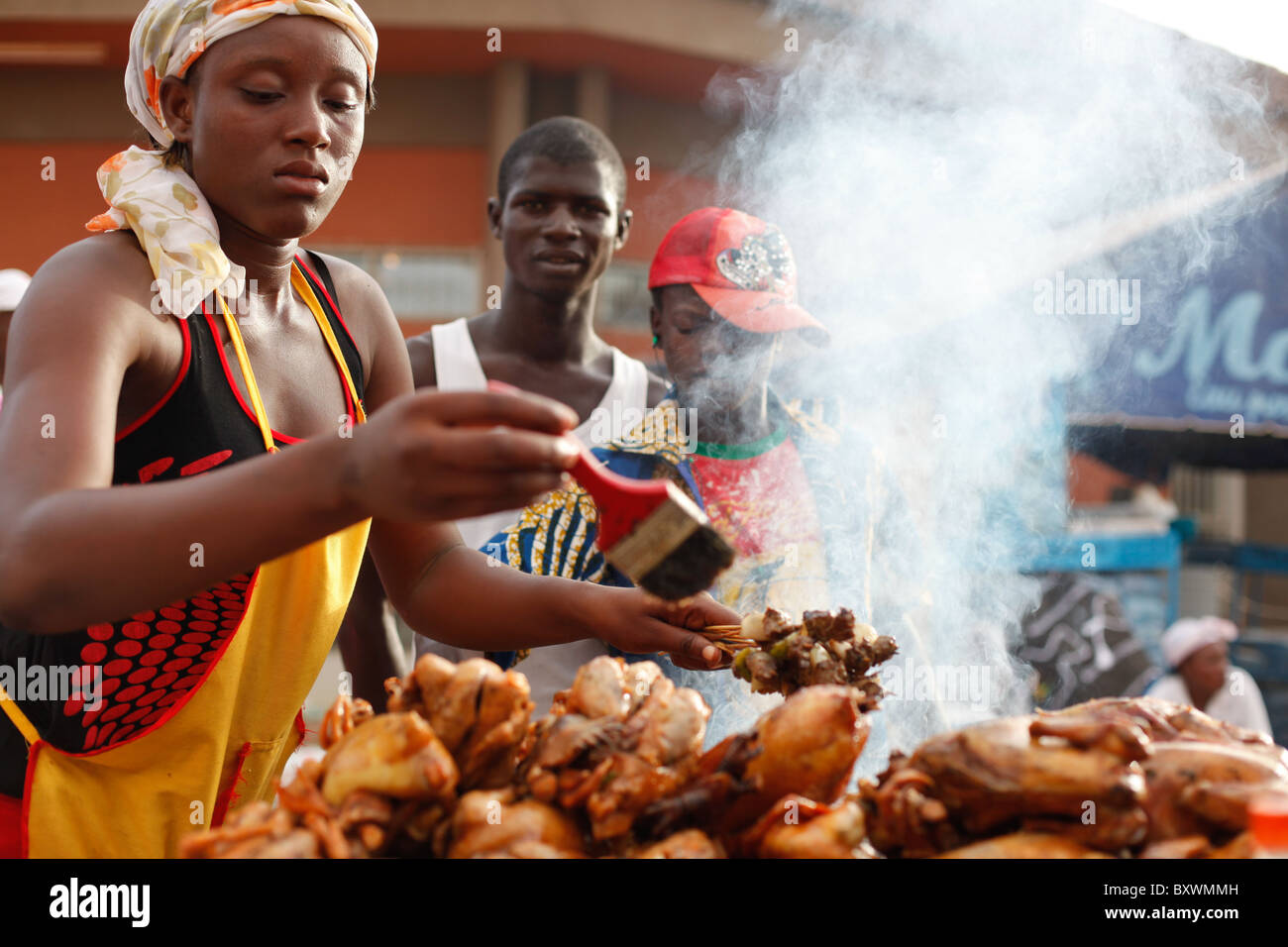 Vendors sell brochettes, chicken, and other food at the Salon International de l'Artisanat de Ouagadougou, Burkina Faso. Stock Photo