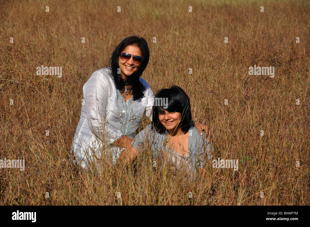smiling girls in a grass land Stock Photo - Alamy