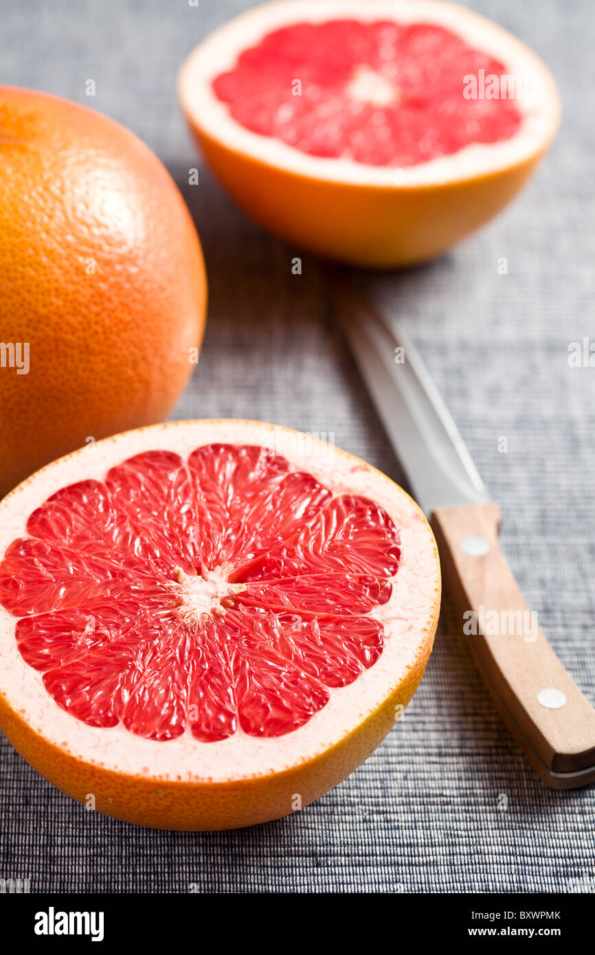 the sliced red grapefruit on kitchen table Stock Photo