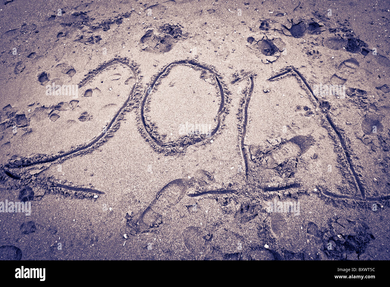 '2011' drawn into the sand on a beach. Stock Photo