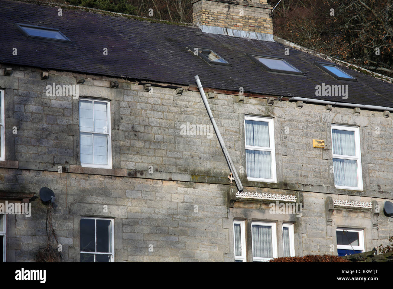 House with snow damage to the rainwater guttering. Stock Photo