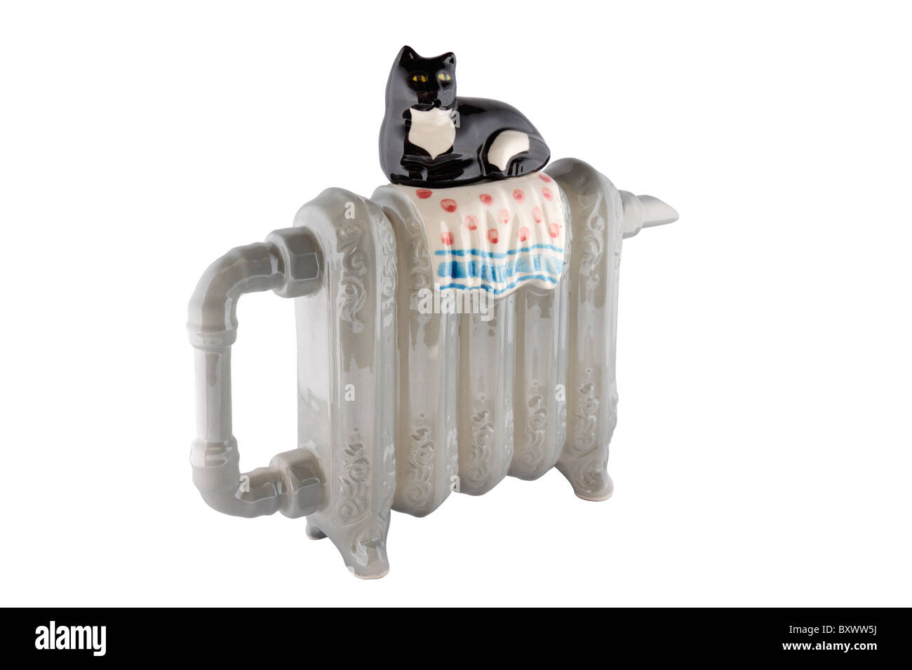 Ornamental novelty teapot in the shape of an old fashioned cast iron radiator with a cat for a lid Stock Photo