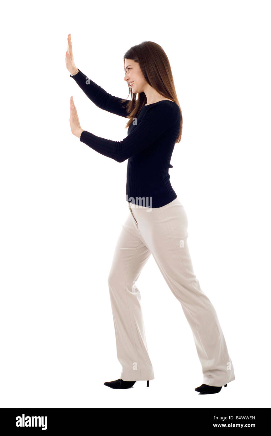 Woman pushing an imaginary object isolated over a white background Stock Photo