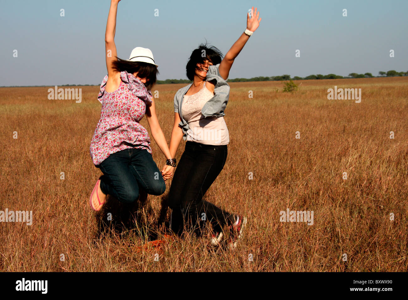 Two indian girls jumping Stock Photo Alamy