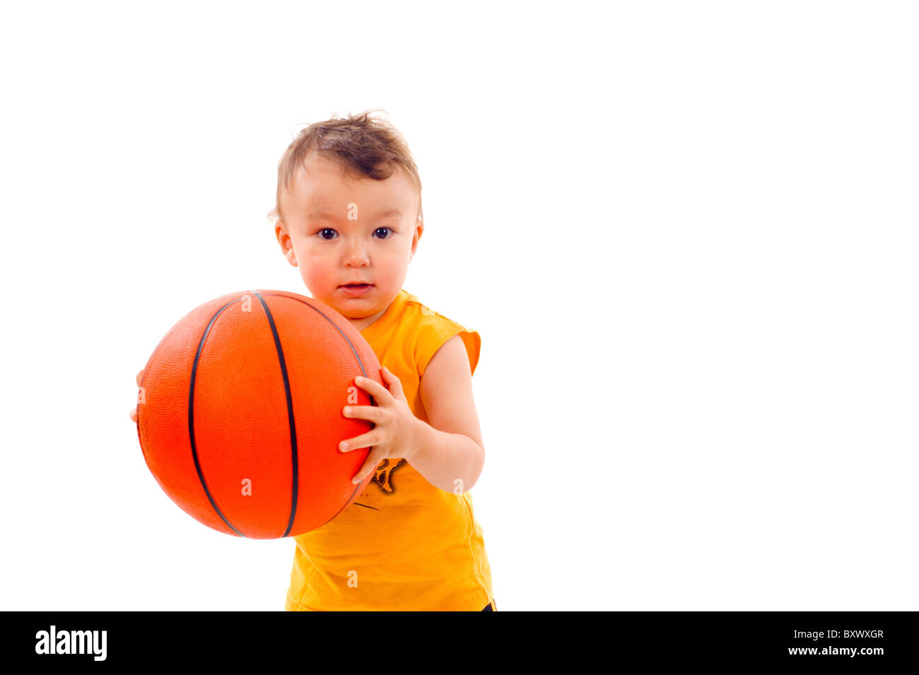 Adorable baby boy playing basketball hi-res stock photography and