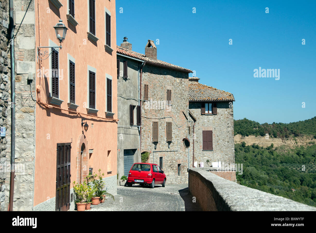 Red car parked in the Umbrian town of Ficulle, Italy Stock Photo