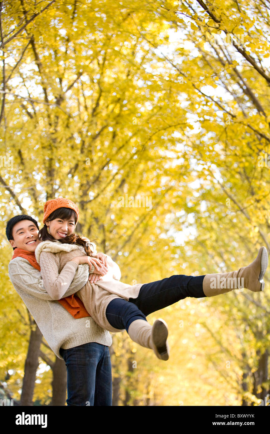 Young Man Playfully Picking Up His Girlfriend Stock Photo Alamy