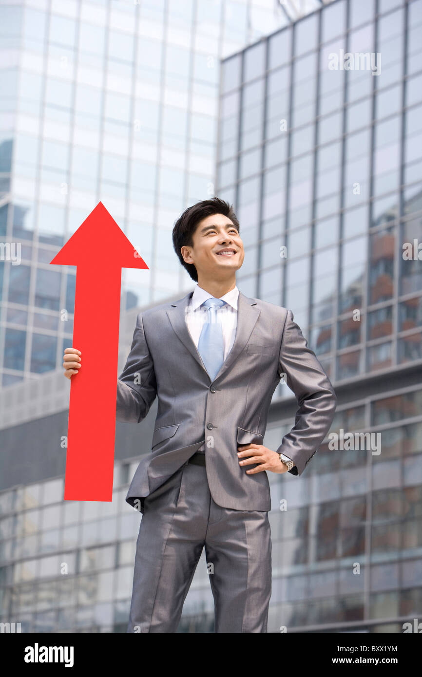 Chinese businessman with a red arrow Stock Photo - Alamy