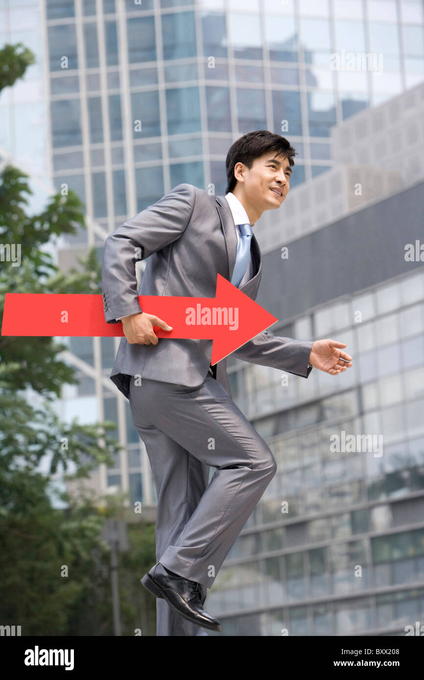 Chinese businessman with a red arrow Stock Photo - Alamy