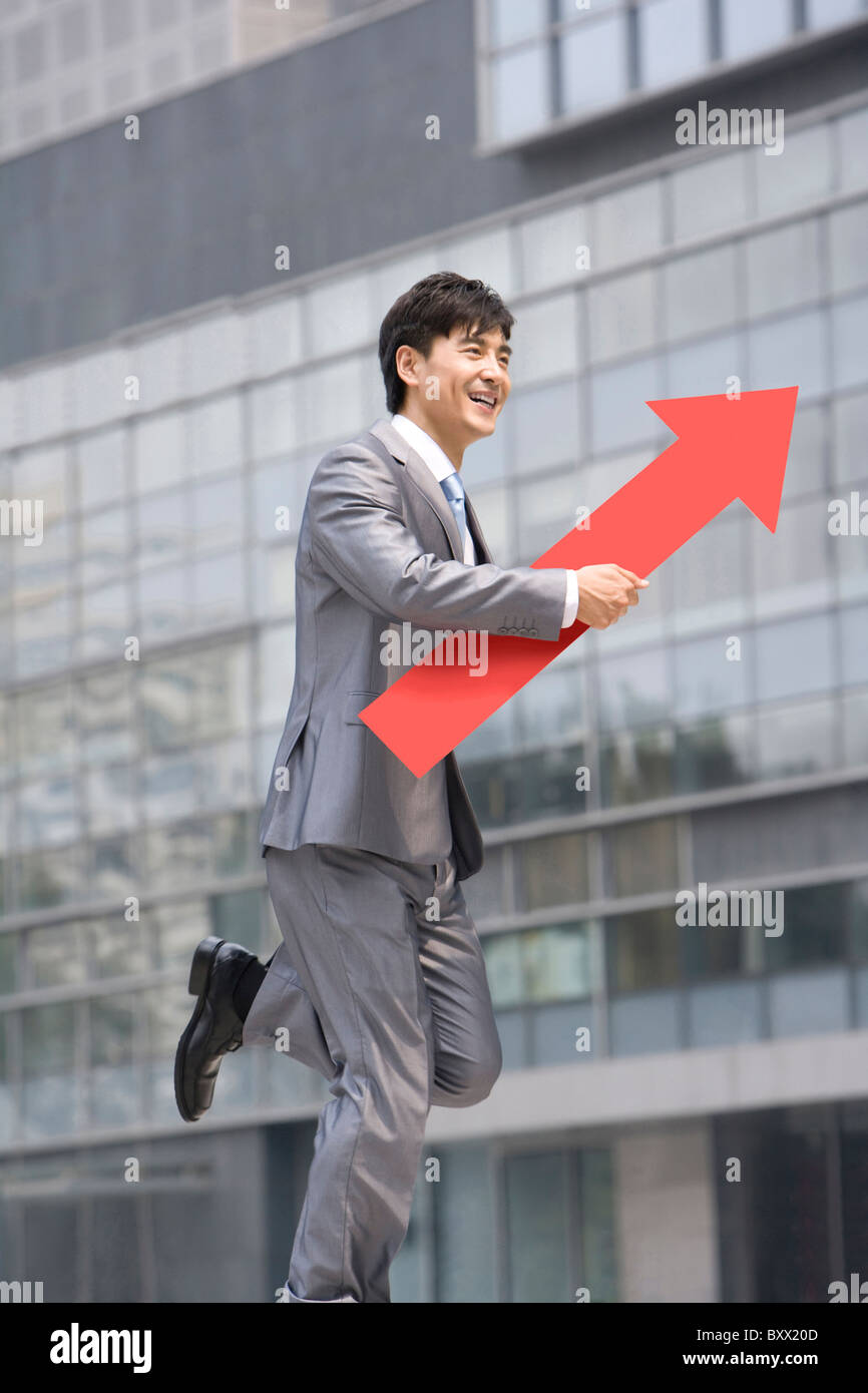 Chinese businessman with a red arrow Stock Photo - Alamy