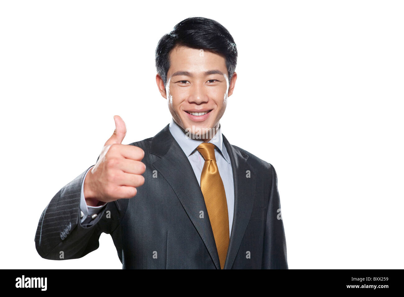 Businessman smiling with thumbs up Stock Photo - Alamy