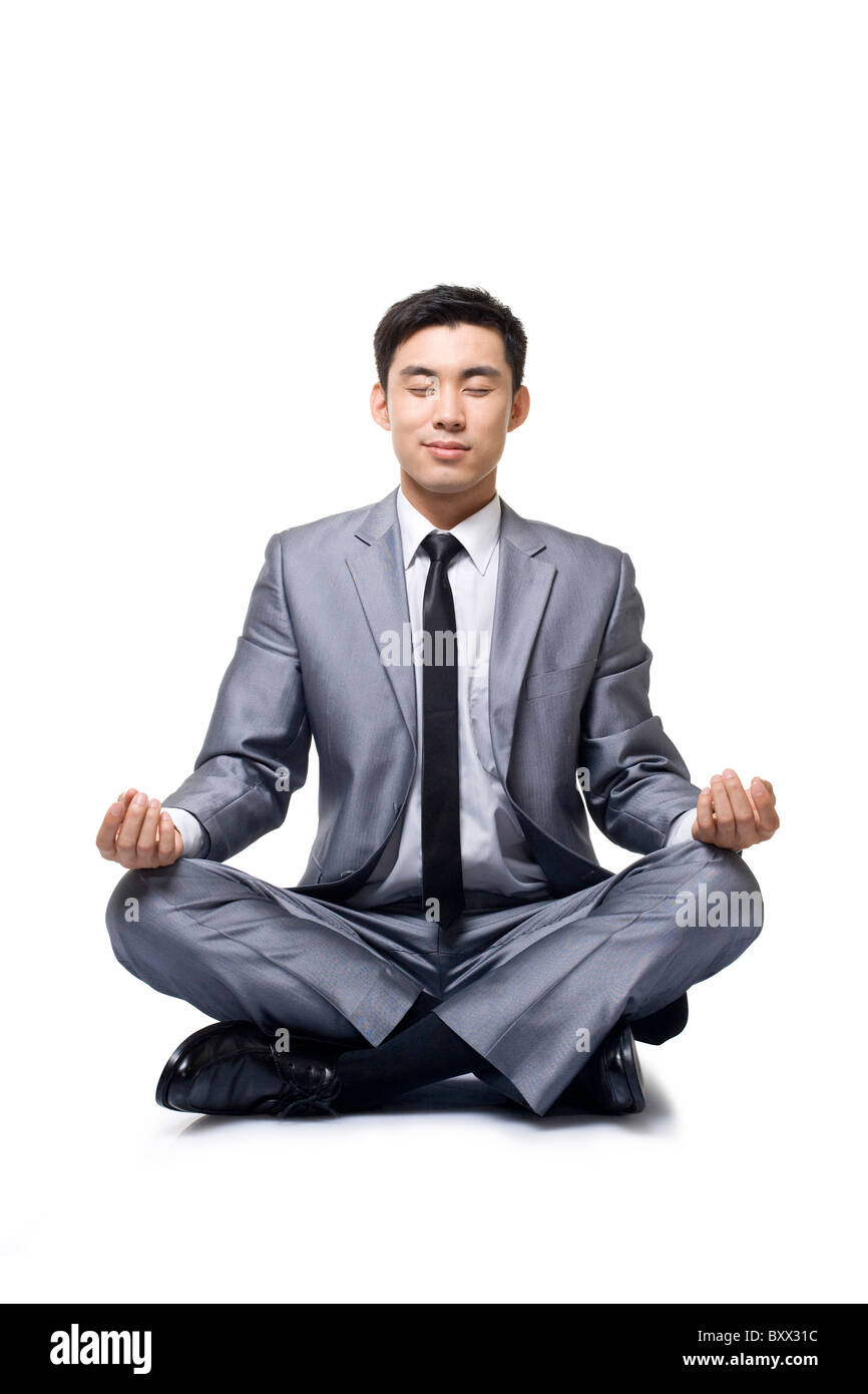 Businessman doing yoga Stock Photo - Alamy