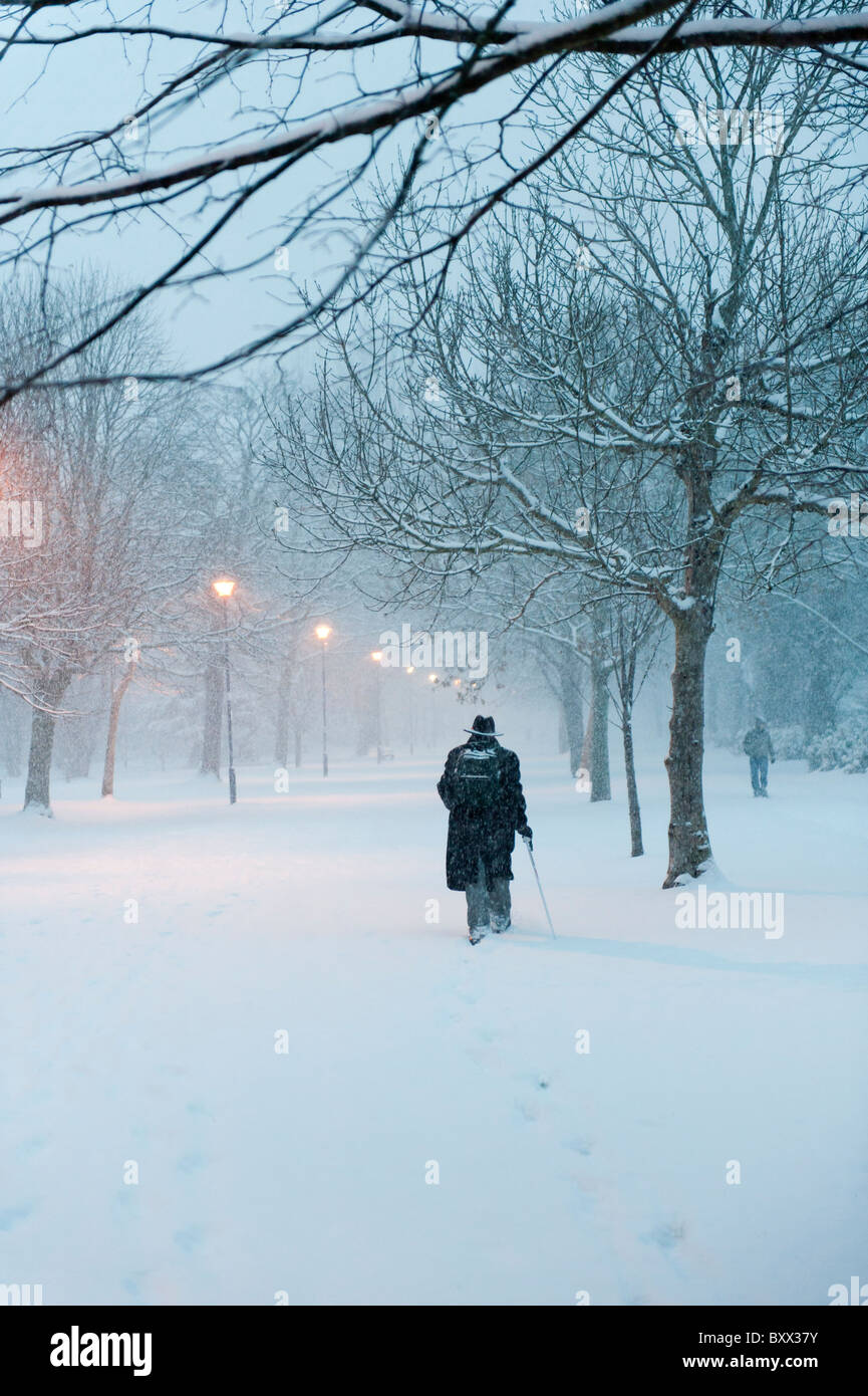 Early morning, rear view of people walking in the snow, Aberystwyth Wales UK December 2010 Stock Photo