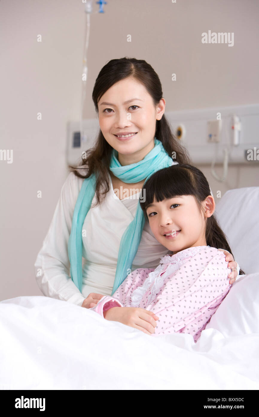 Mother comforting her daughter on a hospital bed Stock Photo - Alamy