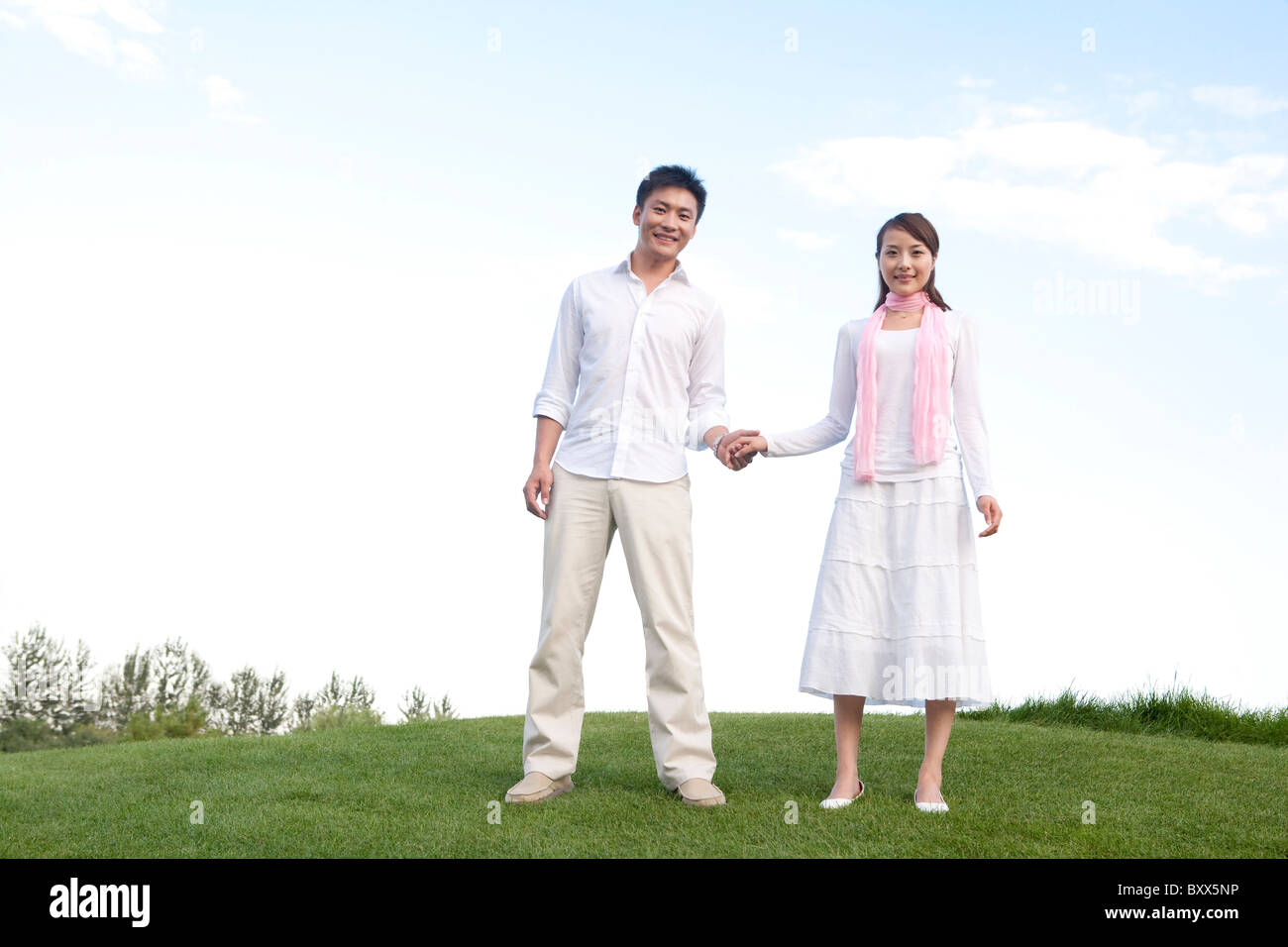 Young couple enjoying the park Stock Photo - Alamy
