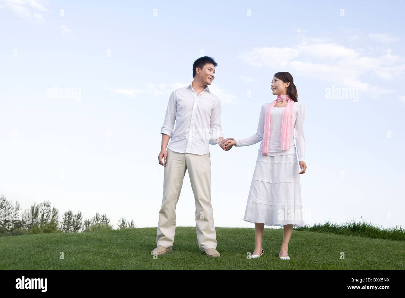 Young couple enjoying the park Stock Photo - Alamy