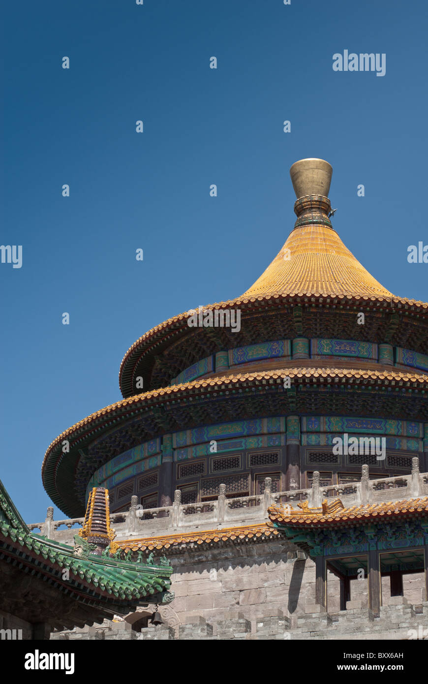 A round pavilion with golden tiles roof in a tibetan buddhist temple Stock Photo