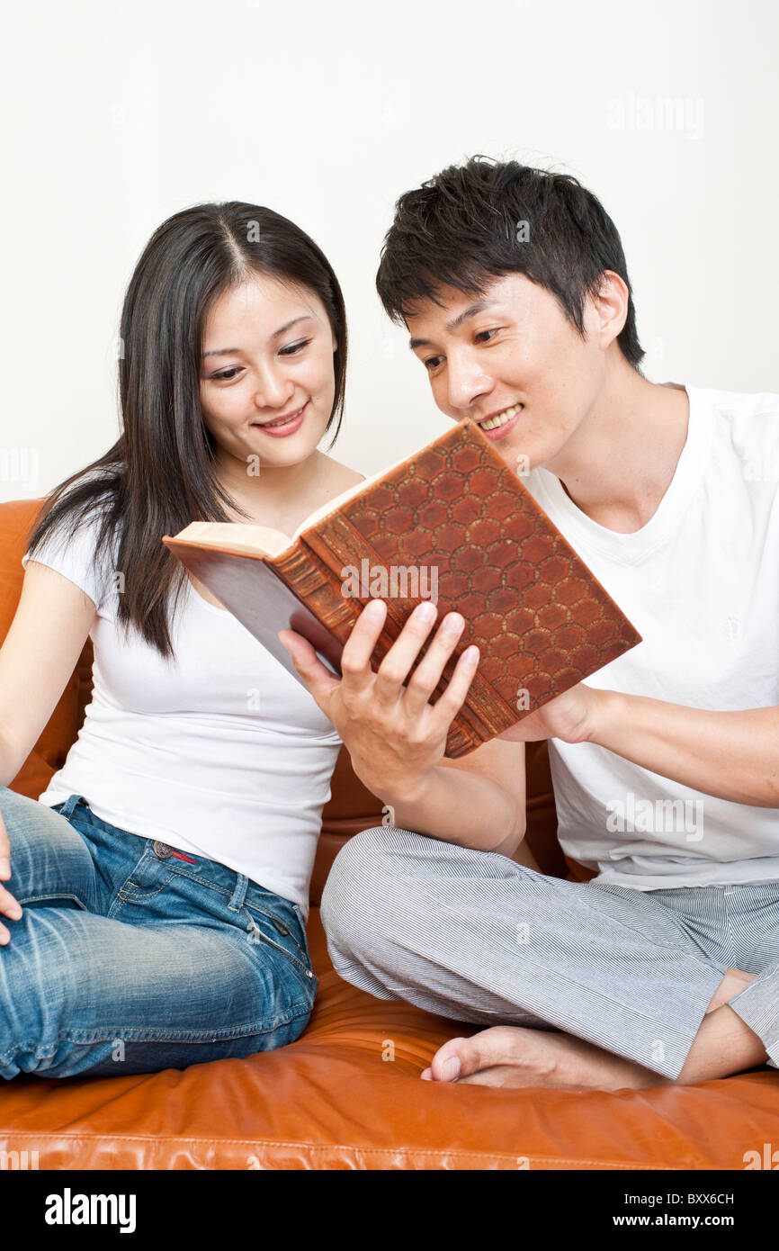 Man and Woman Reading a Book Together Stock Photo - Alamy