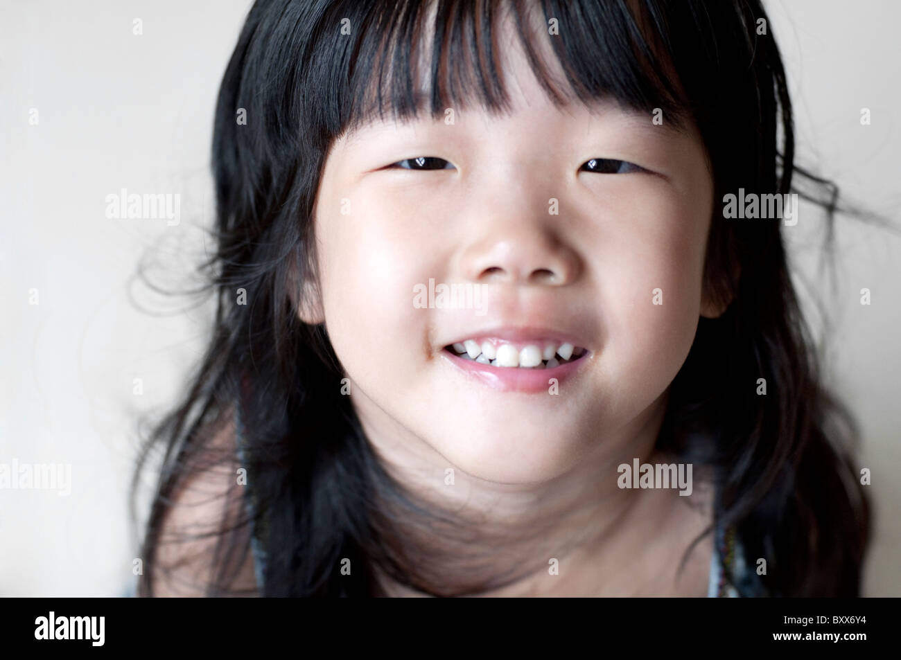 Portrait of single eyelid little Asian girl smiling, looking up Stock ...