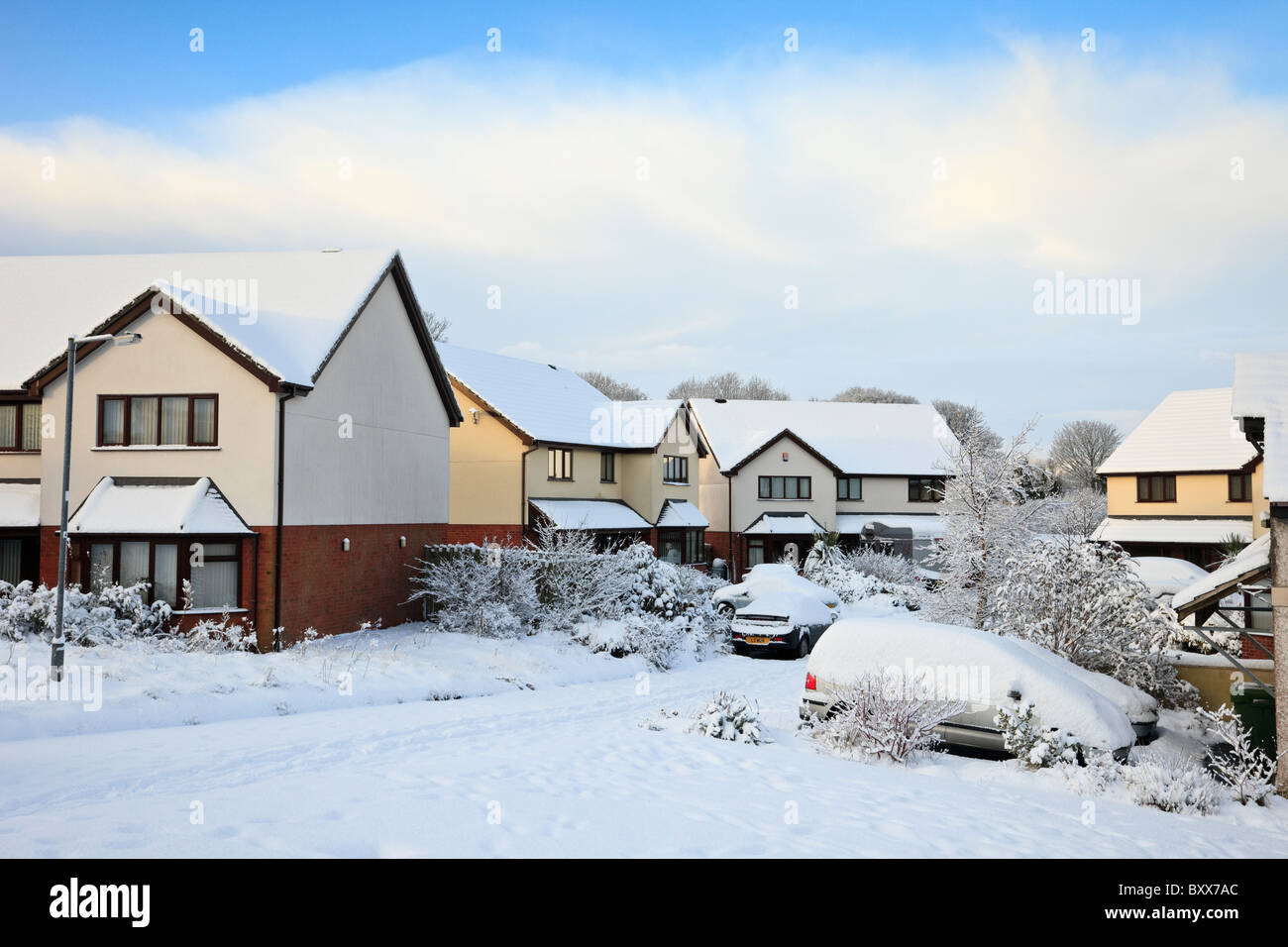 Snow on suburban estate residential street and houses after heavy winter snowfall in December 2010. Wales UK Britain Stock Photo